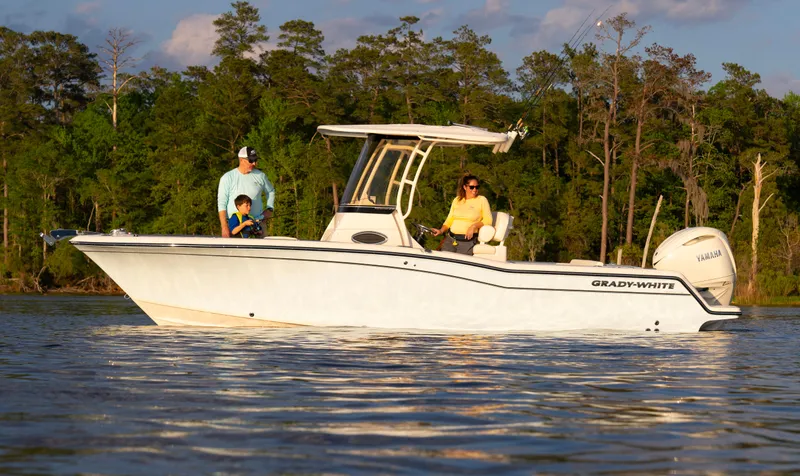 The Image of 2025 Grady-White Fisherman 236 boat on water with people, surrounded by trees. - 1