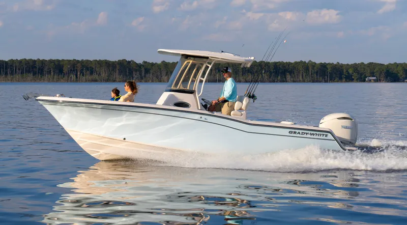 Slide: The Image of 2025 Grady-White Fisherman 236 boat cruising on a calm lake with passengers. - 3