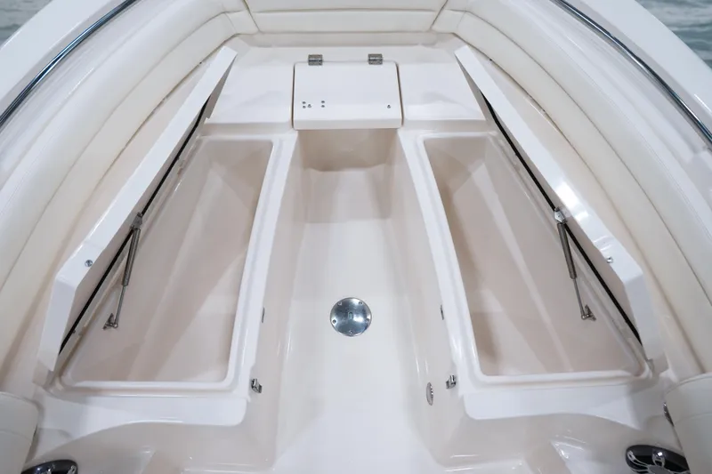 Slide: The Image of 2025 Grady-White Fisherman 236 boat interior with open storage compartments. - 6