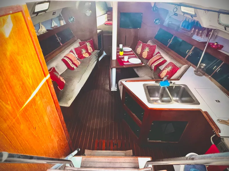 Slide: The Image of Interior of a 1988 Hunter 40 sailboat with cozy seating and kitchen area. - 16