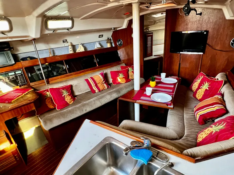 Slide: The Image of Interior of 1988 Hunter 40 yacht with cozy seating, vibrant pillows, and dining setup. - 19