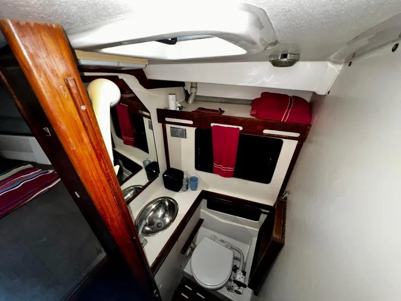 Slide: The Image of Interior of 1988 Hunter 40 sailboat bathroom with sink, toilet, and wooden accents. - 22