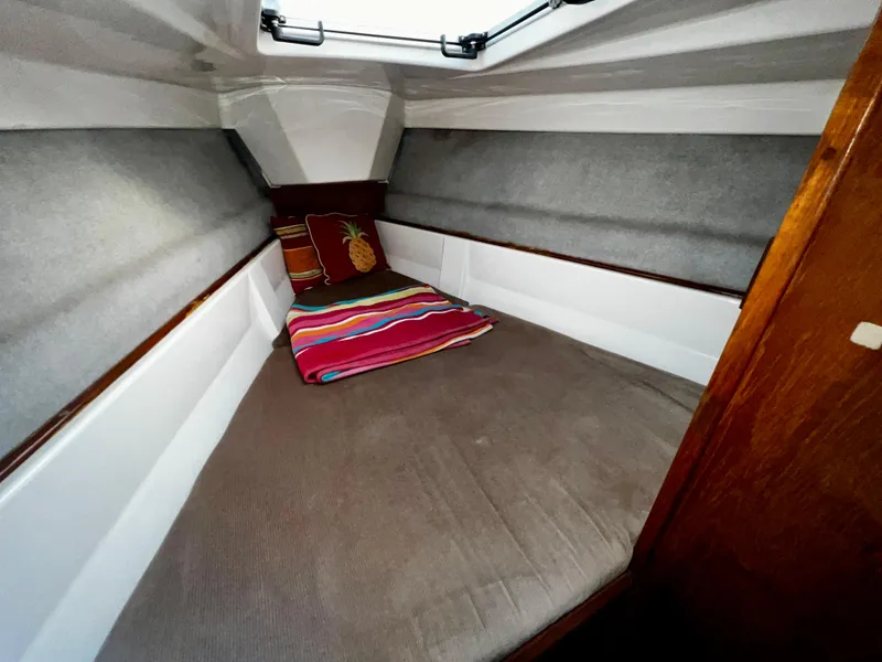 Slide: The Image of Cozy cabin interior of 1988 Hunter 40 sailboat with colorful bedding and pillows. - 23