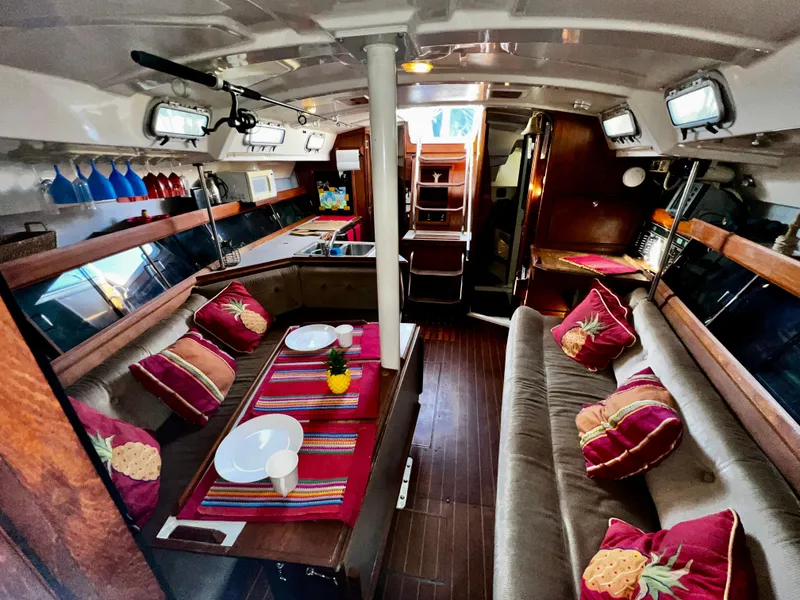 Slide: The Image of Interior of 1988 Hunter 40 sailboat with cozy seating and vibrant decor. - 24