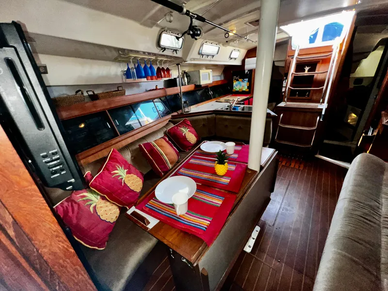 Slide: The Image of Interior of 1988 Hunter 40 sailboat with cozy dining area and colorful decor. - 26