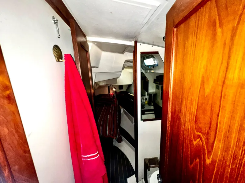 Slide: The Image of Interior of 1988 Hunter 40 sailboat with wooden finishes and red towel hanging. - 27