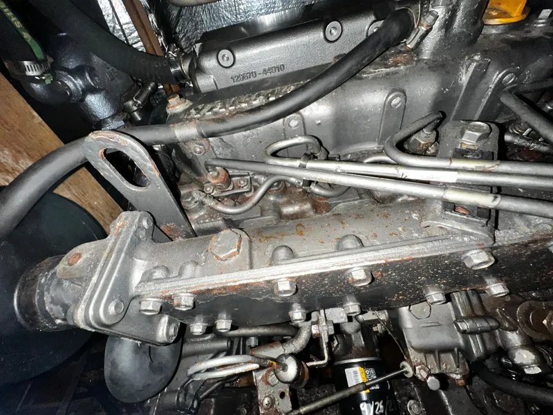 Slide: The Image of Close-up of a 1988 Hunter 40 engine with visible components and bolts. - 31