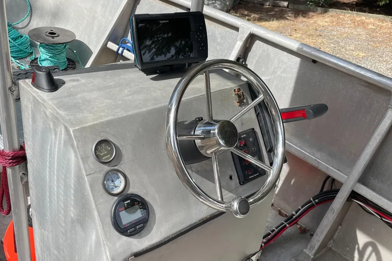 Slide: The Image of Steering console of a 2006 Pacific Boats 22 with gauges and navigation equipment. - 3
