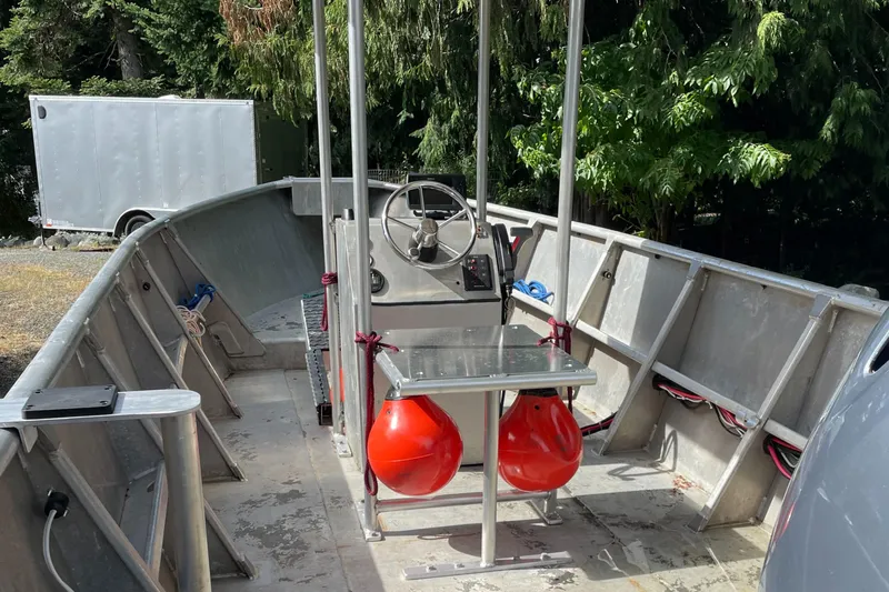 Slide: The Image of 2006 Pacific Boats 22 interior with steering wheel, metal deck, and red buoys. - 4