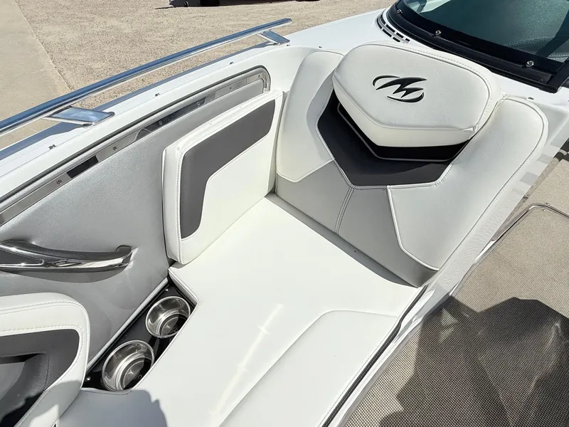Slide: The Image of 2018 Monterey 218 Super Sport boat interior with white seating and cup holders. - 11