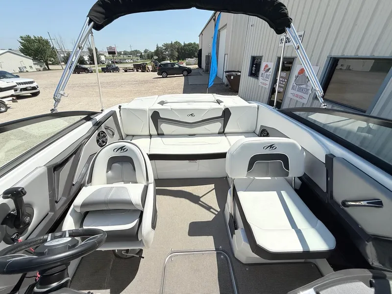 Slide: The Image of 2018 Monterey 218 Super Sport boat interior with white seating and steering wheel. - 15