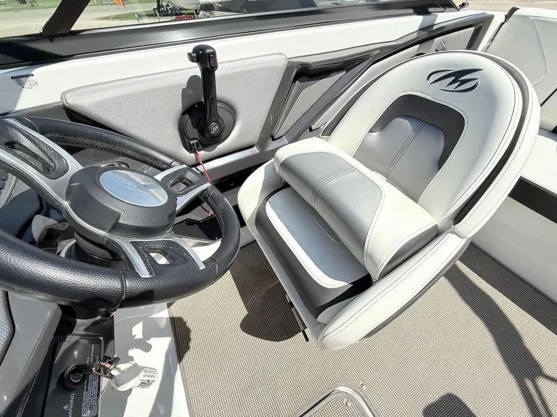 Slide: The Image of 2018 Monterey 218 Super Sport boat interior with steering wheel and cushioned seat. - 16
