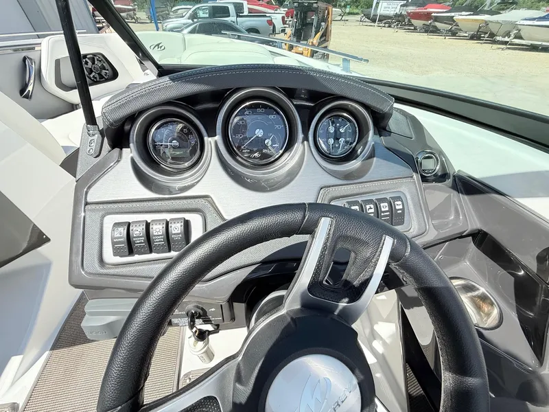 Slide: The Image of Dashboard of 2018 Monterey 218 Super Sport boat with steering wheel and gauges. - 17