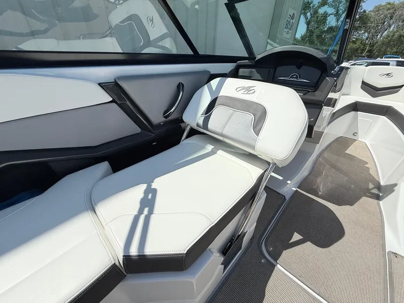 Slide: The Image of 2018 Monterey 218 Super Sport boat interior with white and gray seating. - 24