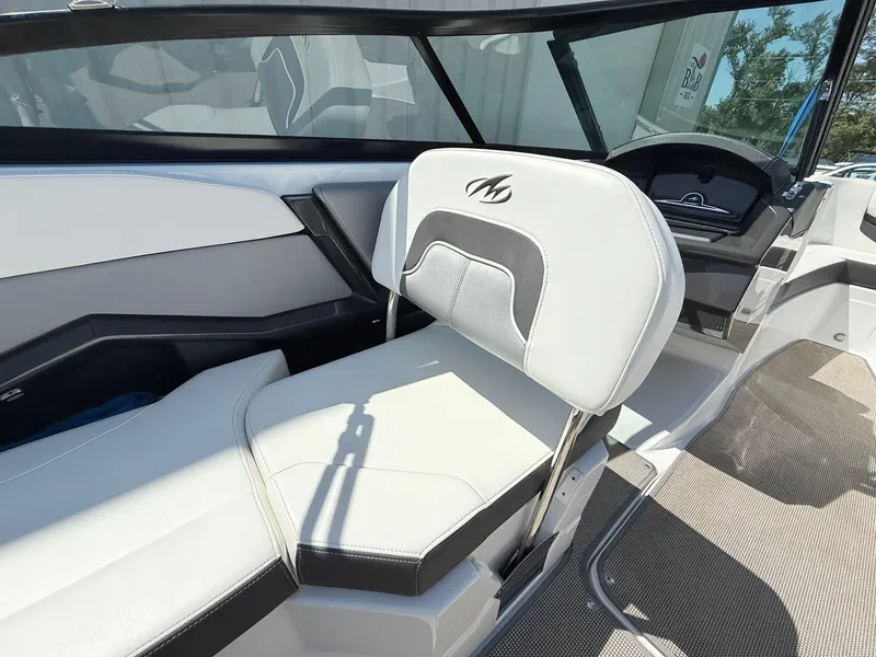 Slide: The Image of 2018 Monterey 218 Super Sport boat interior with sleek white seating and modern dashboard. - 25