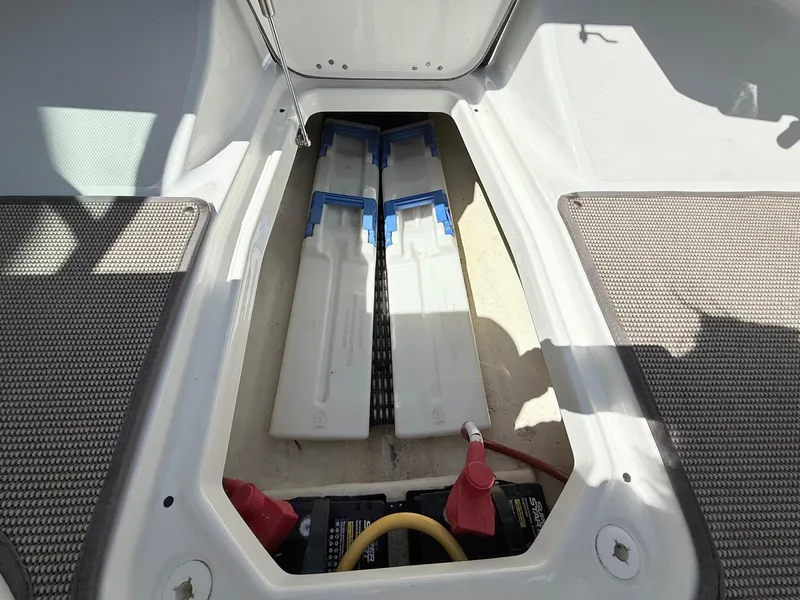 Slide: The Image of 2018 Monterey 218 Super Sport boat storage compartment with batteries and equipment. - 26