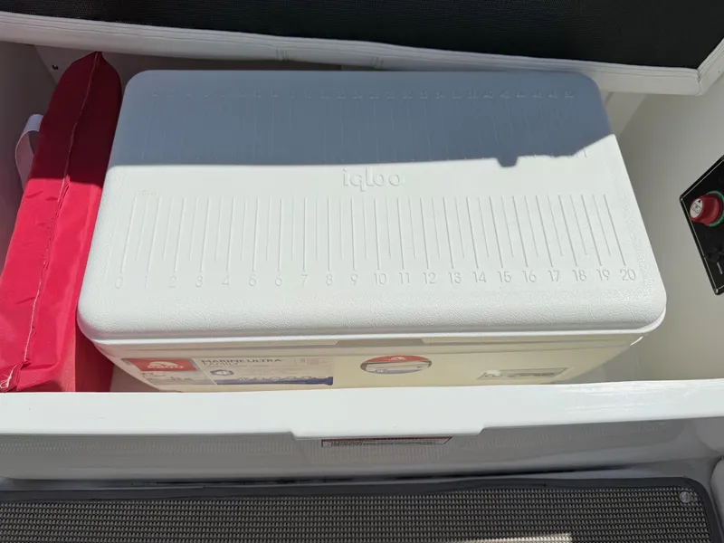 Slide: The Image of White Igloo cooler in 2018 Monterey 218 Super Sport boat storage compartment. - 31