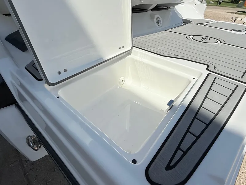 Slide: The Image of Open storage compartment on a 2018 Monterey 218 Super Sport boat. - 35