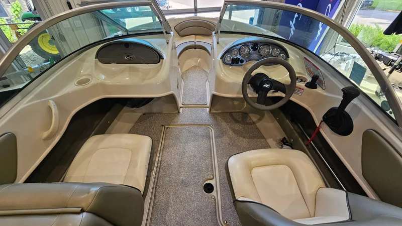 Slide: The Image of 2005 Sea Ray 180 Sport boat interior with steering wheel and seating. - 10
