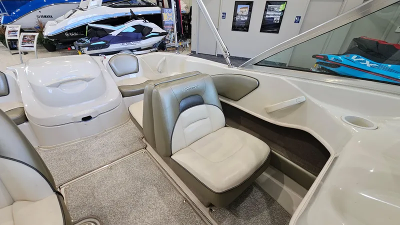Slide: The Image of 2005 Sea Ray 180 Sport boat interior with seating and carpeted flooring. - 11