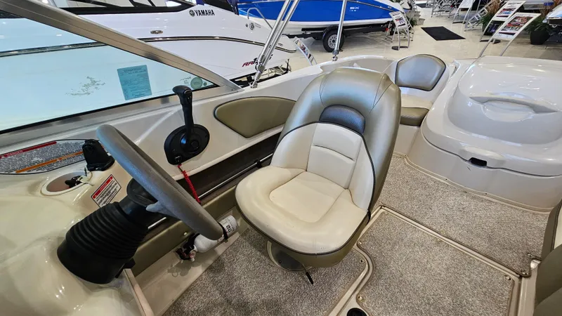 Slide: The Image of Interior of a 2005 Sea Ray 180 Sport boat, featuring steering wheel and seating. - 12