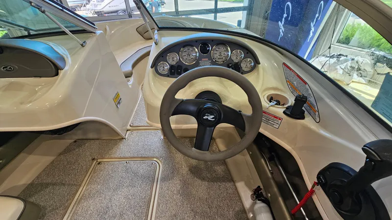 Slide: The Image of Interior view of 2005 Sea Ray 180 Sport boat dashboard and steering wheel. - 13
