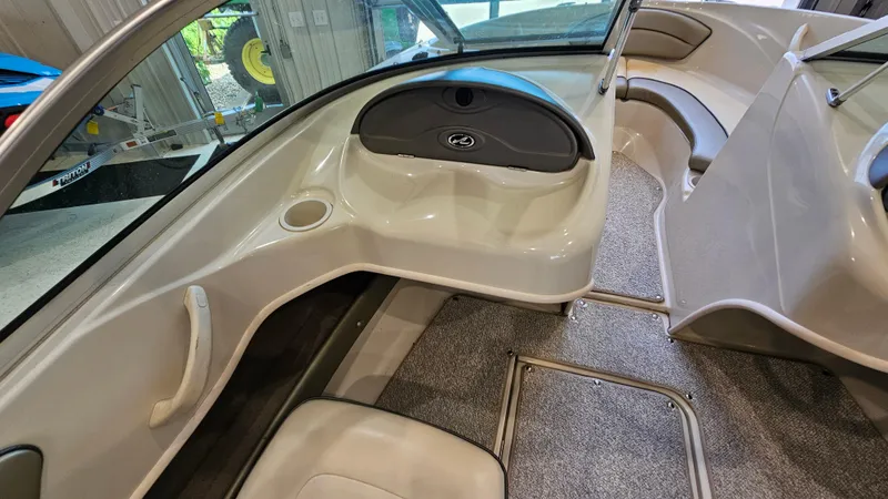 Slide: The Image of Interior of a 2005 Sea Ray 180 Sport boat, featuring seating and dashboard. - 14