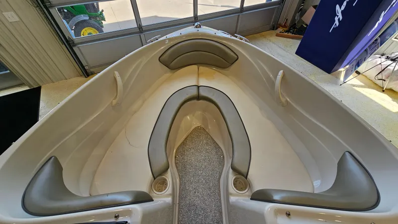 Slide: The Image of Interior view of a 2005 Sea Ray 180 Sport boat, featuring cushioned seating. - 15