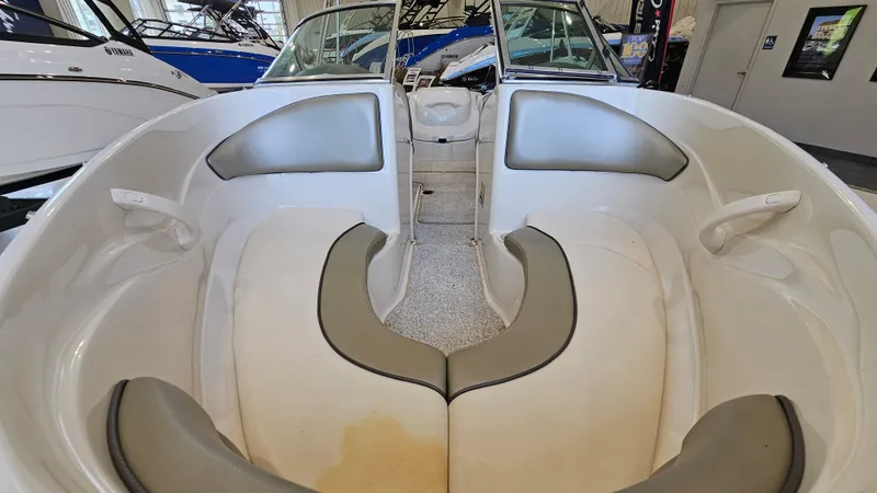 Slide: The Image of 2005 Sea Ray 180 Sport boat interior with cushioned seating and sleek design. - 16