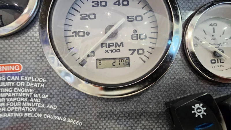 Slide: The Image of Close-up of 2005 Sea Ray 180 Sport dashboard showing RPM and oil pressure gauges. - 18