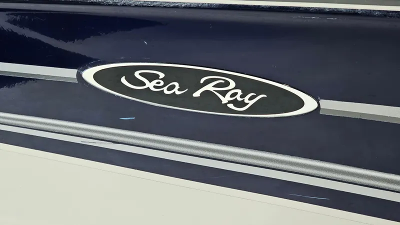 Slide: The Image of Sea Ray 180 Sport 2005 boat logo on dark blue hull. - 20