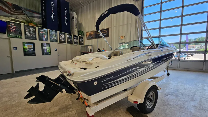 Slide: The Image of 2005 Sea Ray 180 Sport boat displayed indoors on a trailer. - 4