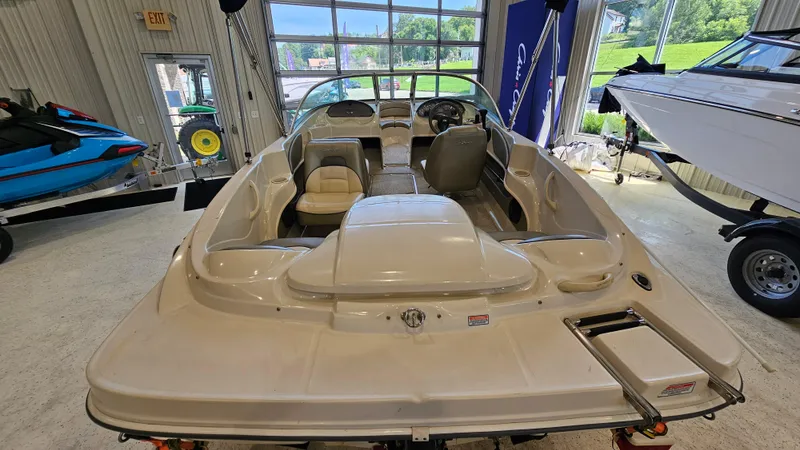 Slide: The Image of 2005 Sea Ray 180 Sport boat interior in showroom, featuring seating and steering wheel. - 5