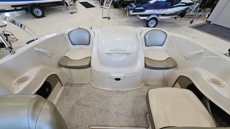 Slide: The Image of 2005 Sea Ray 180 Sport boat interior with seating and storage compartments. - 8