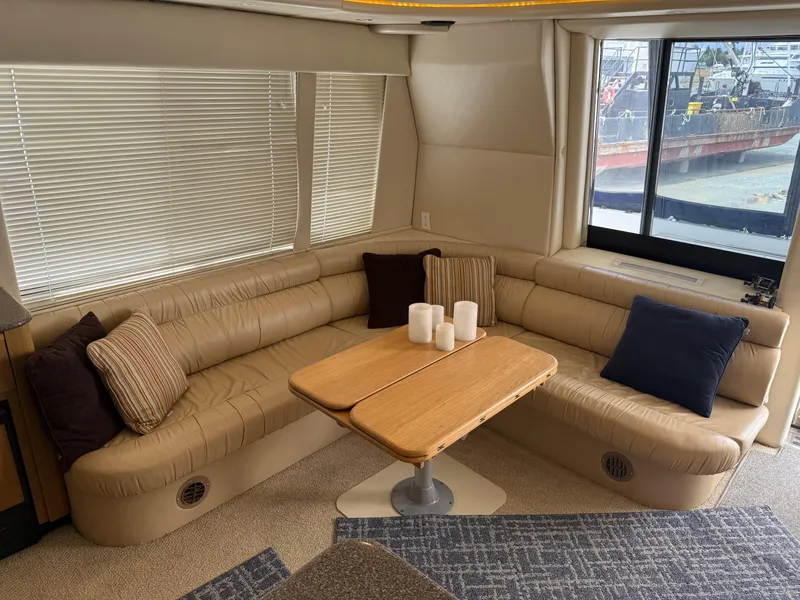 Slide: The Image of Luxurious interior of 2001 Bayliner 5288 Pilot House Motoryacht with plush seating and wooden table. - 11