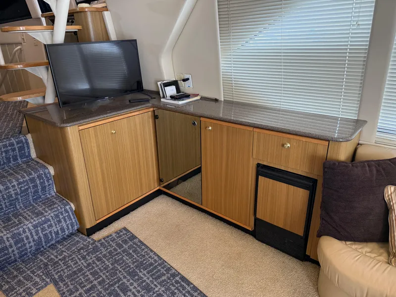 Slide: The Image of Interior of 2001 Bayliner 5288 Pilot House Motoryacht with TV, cabinets, and stairs. - 13