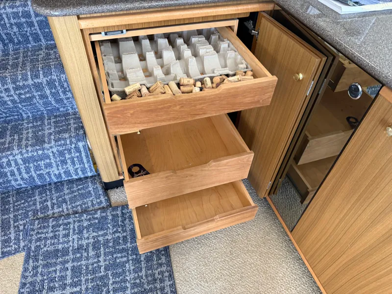 Slide: The Image of Open wooden drawers with wine corks in a Bayliner 5288 Pilot House Motoryacht, 2001. - 16
