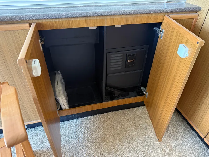Slide: The Image of Open cabinet on 2001 Bayliner 5288 Pilot House Motoryacht, revealing interior storage space. - 19