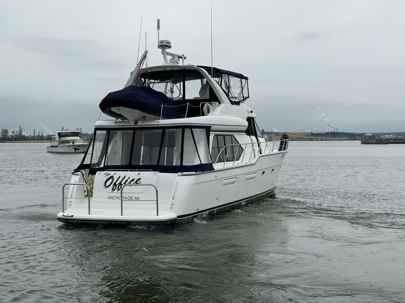 Slide: The Image of 2001 Bayliner 5288 Pilot House Motoryacht cruising on a calm waterway. - 2