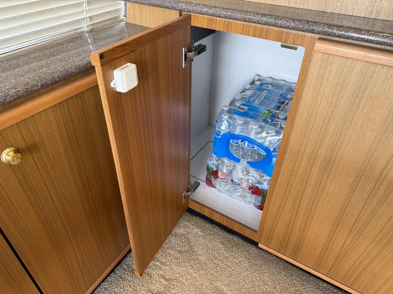 Slide: The Image of Cabinet on 2001 Bayliner 5288 yacht, storing bottled water packs. - 21