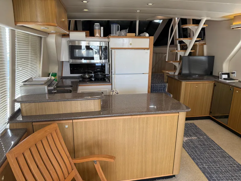 Slide: The Image of Interior of 2001 Bayliner 5288 Pilot House Motoryacht with kitchen and seating area. - 22