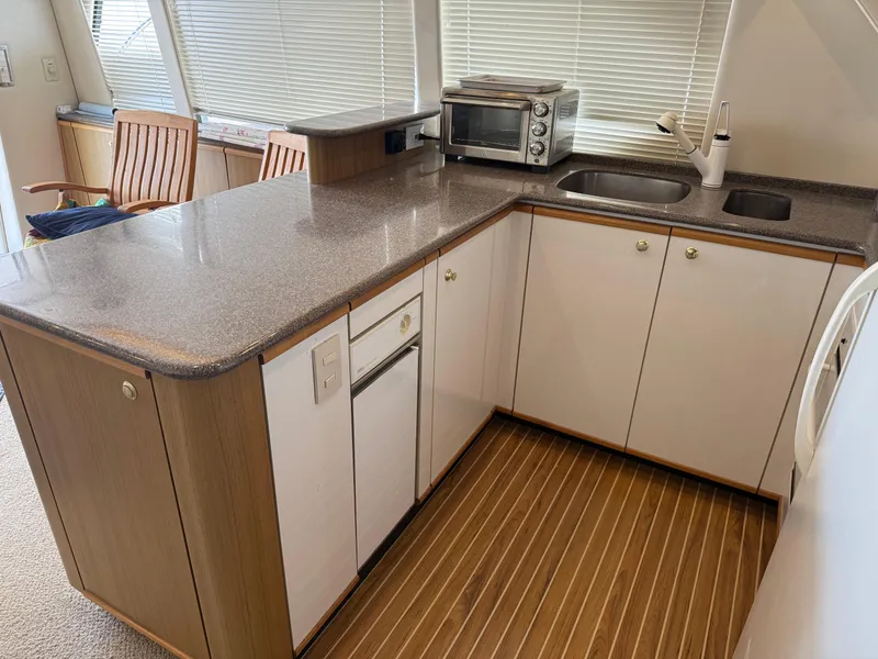 Slide: The Image of 2001 Bayliner 5288 Pilot House Motoryacht kitchen with modern appliances and sleek countertops. - 24