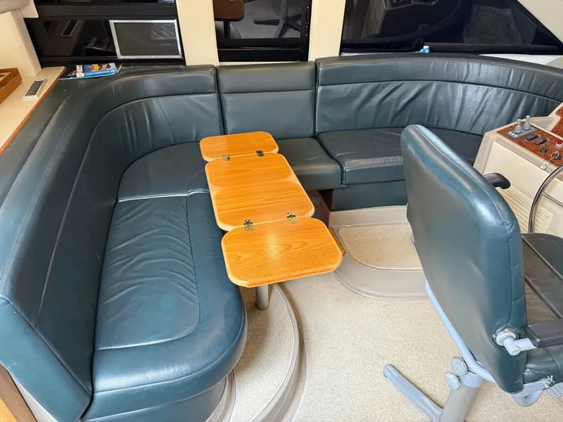 Slide: The Image of 2001 Bayliner 5288 Pilot House Motoryacht interior with leather seating and wooden table. - 29