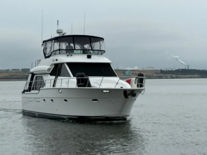 Slide: The Image of 2001 Bayliner 5288 Pilot House Motoryacht cruising on a calm waterway. - 3