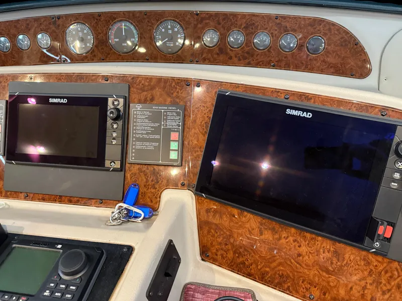 Slide: The Image of Dashboard of 2001 Bayliner 5288 Pilot House Motoryacht with Simrad navigation displays. - 31
