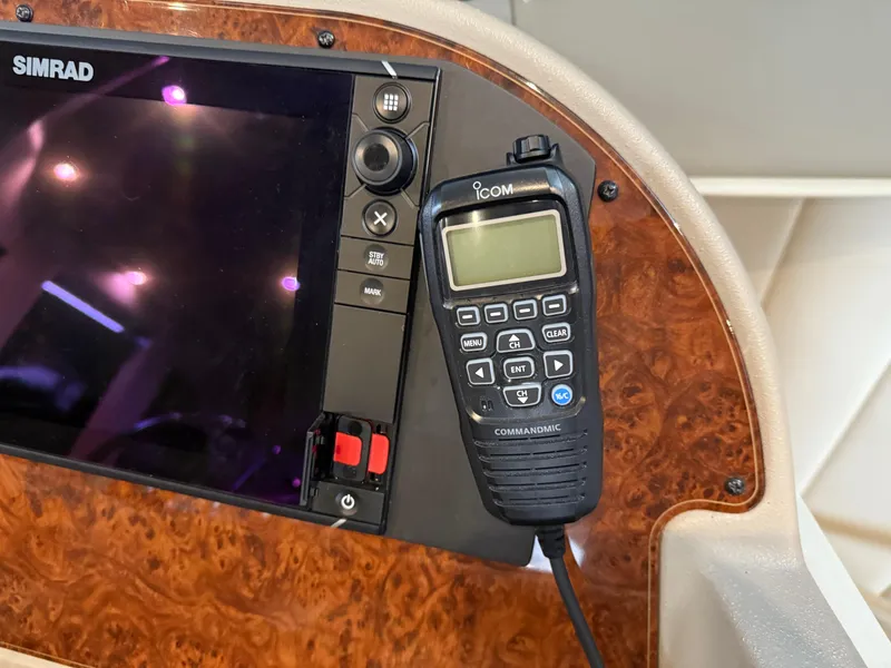 Slide: The Image of Control panel of 2001 Bayliner 5288 Pilot House Motoryacht with Simrad display and Icom CommandMic. - 32