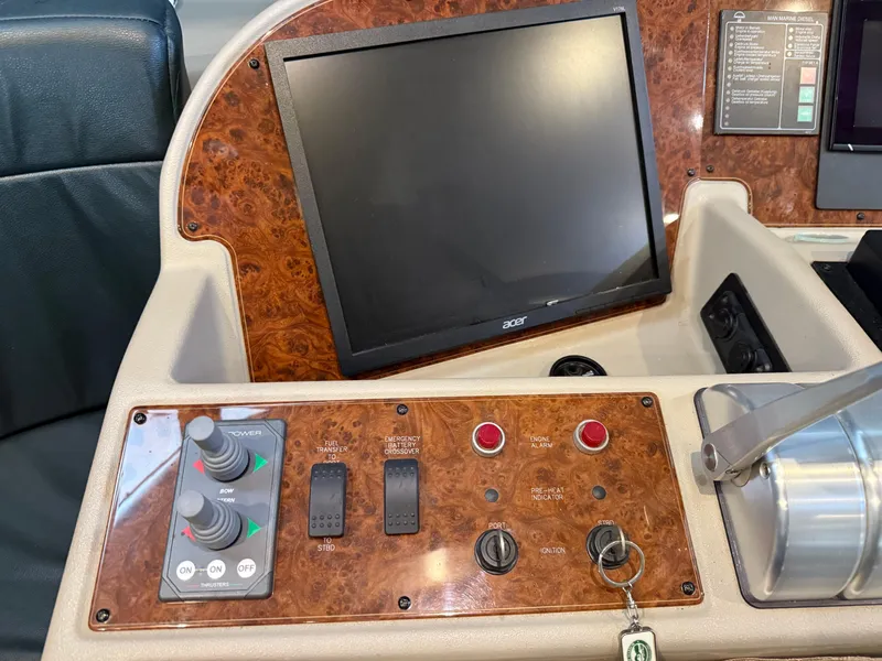 Slide: The Image of Control panel of 2001 Bayliner 5288 Pilot House Motoryacht with screen and switches. - 34