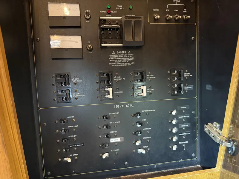 Slide: The Image of Electrical panel of a 2001 Bayliner 5288 Pilot House Motoryacht, featuring various switches and controls. - 38