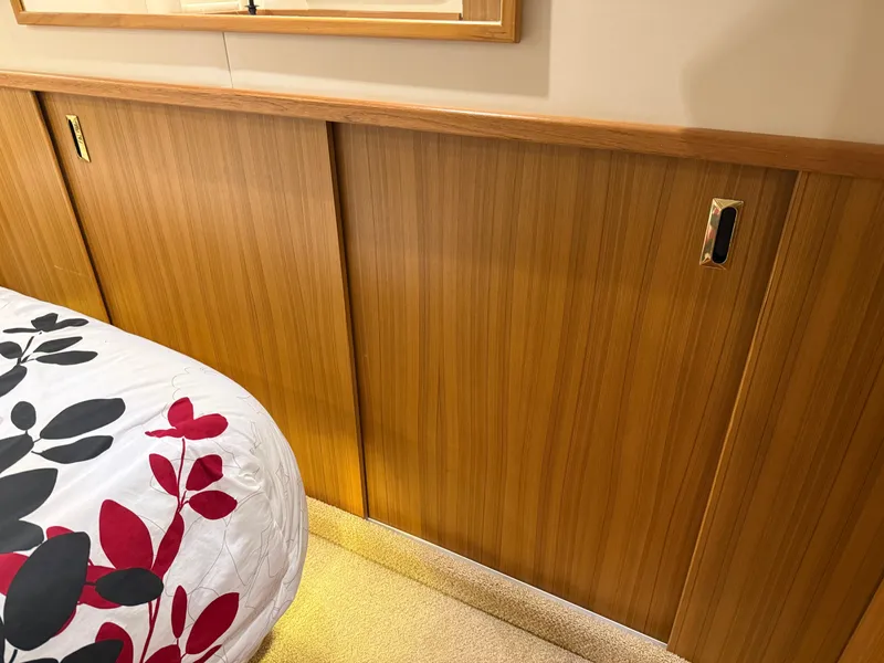 Slide: The Image of Wood-paneled interior of 2001 Bayliner 5288 Pilot House Motoryacht with floral bedding. - 44