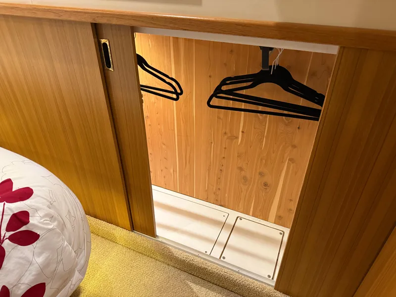 Slide: The Image of Wooden closet with hangers in 2001 Bayliner 5288 Pilot House Motoryacht interior. - 45